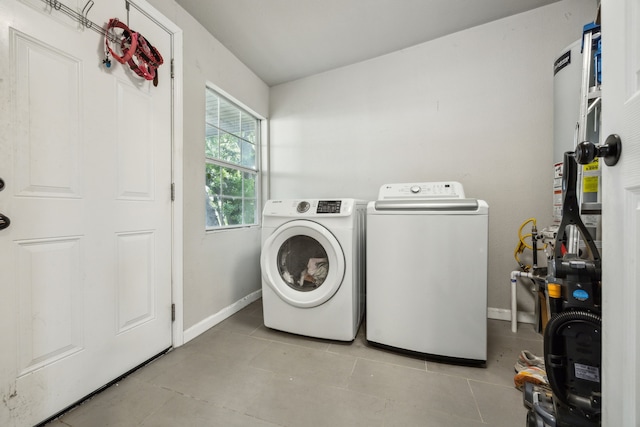 1215 Morrell Ave, Dallas, TX 75203 - washroom featuring washing machine and dryer, baseboards, and tile patterned floors