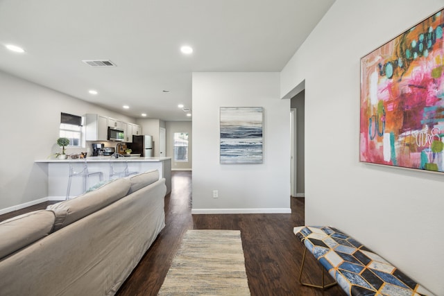 1215 Morrell Ave, Dallas, TX 75203 - living area featuring recessed lighting, dark wood-style floors, plenty of natural light, and baseboards