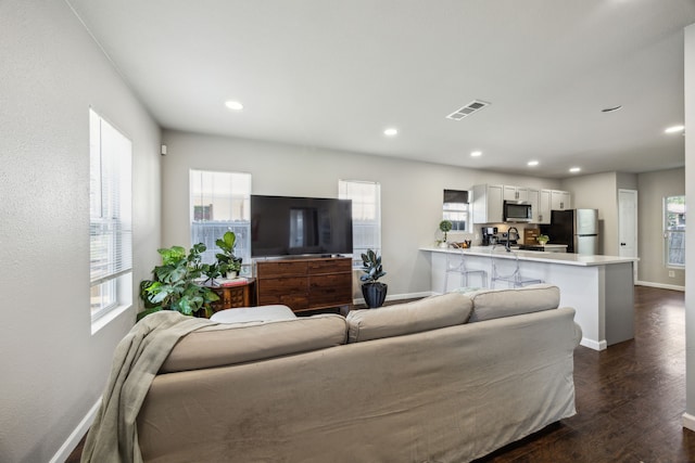 1215 Morrell Ave, Dallas, TX 75203 - living area featuring plenty of natural light, baseboards, dark wood-style floors, and recessed lighting