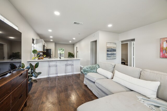 1215 Morrell Ave, Dallas, TX 75203 - living room with dark wood-style flooring, recessed lighting, and baseboards