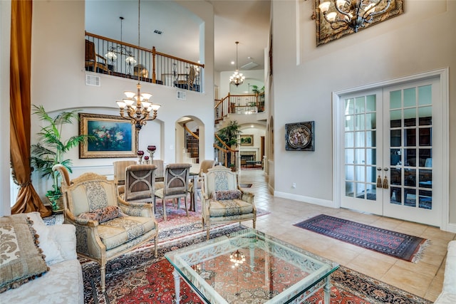 1113 Waterford Way, Allen, TX 75013 - living room featuring a chandelier, arched walkways, stairway, french doors, and a towering ceiling