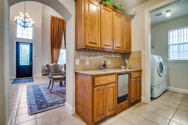 1113 Waterford Way, Allen, TX 75013 - kitchen with a chandelier, washer / clothes dryer, light tile patterned floors, and healthy amount of natural light