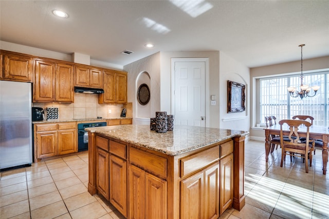 1113 Waterford Way, Allen, TX 75013 - kitchen featuring black appliances, under cabinet range hood, light stone countertops, tasteful backsplash, and light tile patterned floors