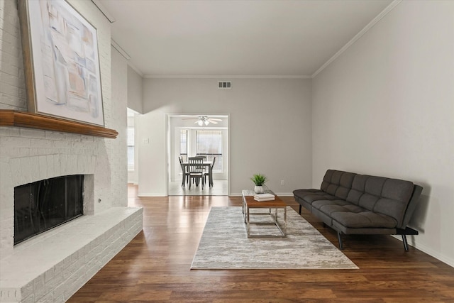 1646 Belltower Dr, Lewisville, TX 75067 - living room featuring dark wood-type flooring, a fireplace, crown molding, ceiling fan, and baseboards