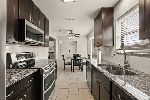 1646 Belltower Dr, Lewisville, TX 75067 - kitchen with appliances with stainless steel finishes, a sink, tasteful backsplash, and stone countertops