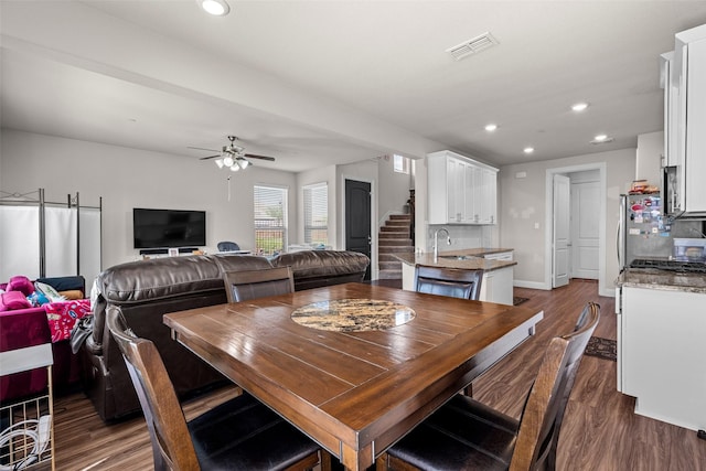 3657 Harebell Dr, Carrollton, TX 75007 - dining space featuring ceiling fan, dark wood-style flooring, recessed lighting, stairs, and baseboards