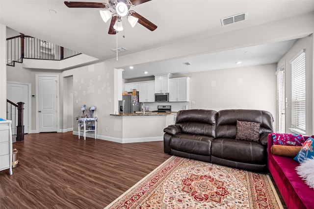3657 Harebell Dr, Carrollton, TX 75007 - living area featuring dark wood finished floors, ceiling fan, stairs, recessed lighting, and baseboards