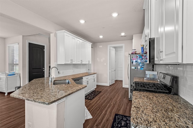 3657 Harebell Dr, Carrollton, TX 75007 - kitchen with a sink, appliances with stainless steel finishes, white cabinetry, backsplash, and a peninsula