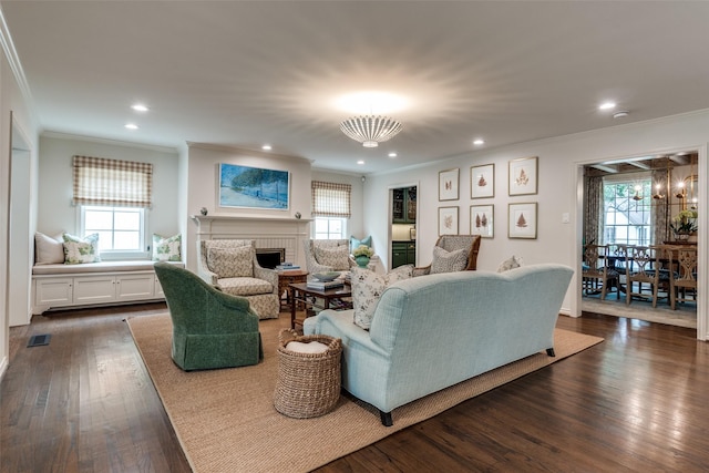 4560 Lorraine Ave, Highland Park, TX 75205 - living room with crown molding, dark wood-style floors, a fireplace, recessed lighting, and a chandelier
