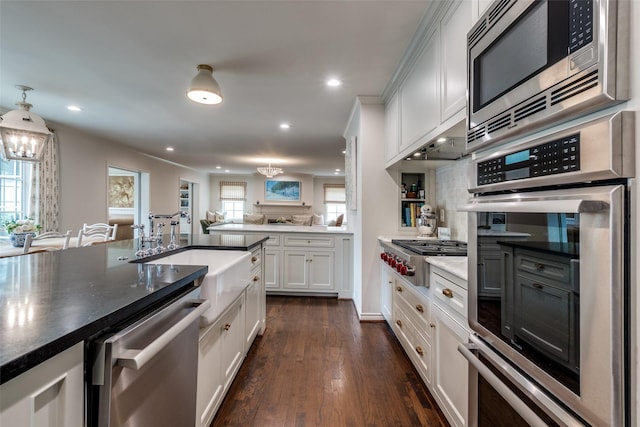 4560 Lorraine Ave, Highland Park, TX 75205 - kitchen with stainless steel appliances, a sink, white cabinetry, a chandelier, and recessed lighting