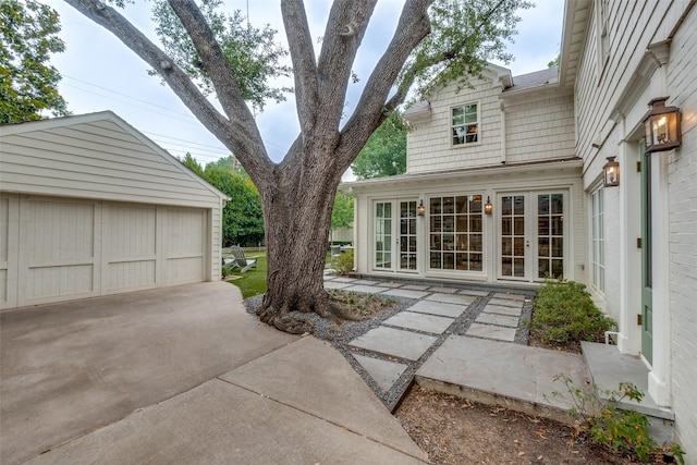 4560 Lorraine Ave, Highland Park, TX 75205 - view of patio featuring a detached garage, an outbuilding, and french doors