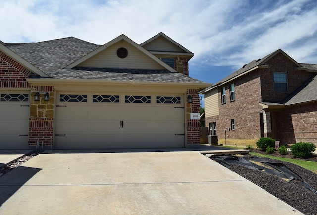 4909-4911 Villas Dr, Sanger, TX 76266 - view of front of home with driveway, brick siding, a garage, cooling unit, and a shingled roof