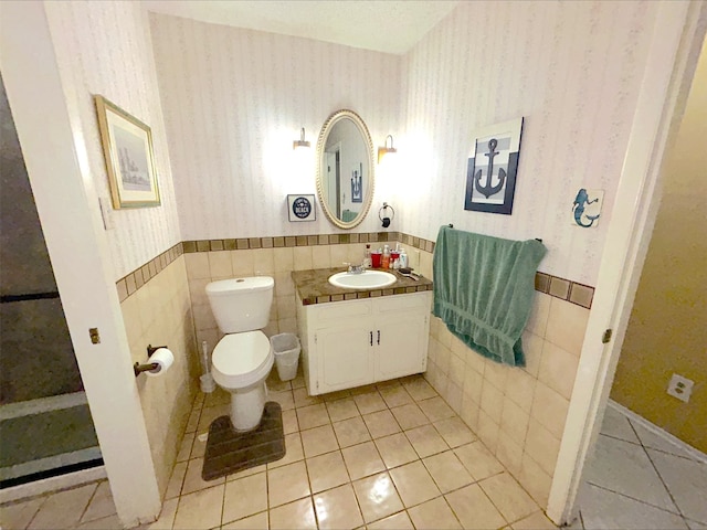 21363 Stevenson Rd, Frankston, TX 75763 - half bath with wallpapered walls, a wainscoted wall, vanity, tile patterned flooring, and toilet