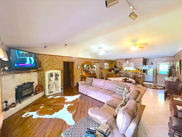 21363 Stevenson Rd, Frankston, TX 75763 - living area with lofted ceiling, a ceiling fan, wooden walls, and rail lighting