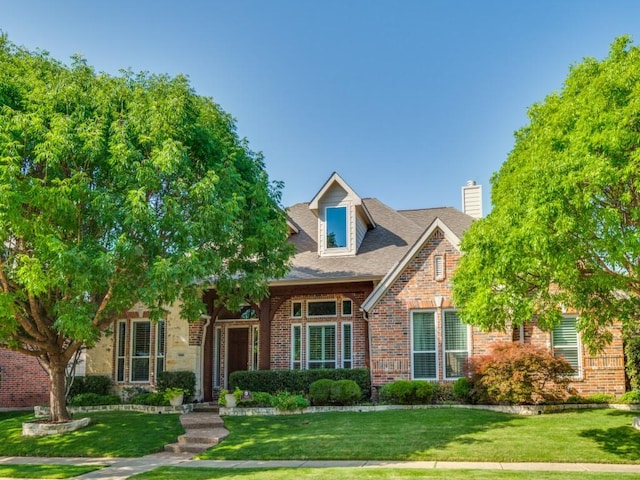 7805 Chapel View Dr, Mckinney, TX 75072 - view of front of property with a front yard, brick siding, and a chimney
