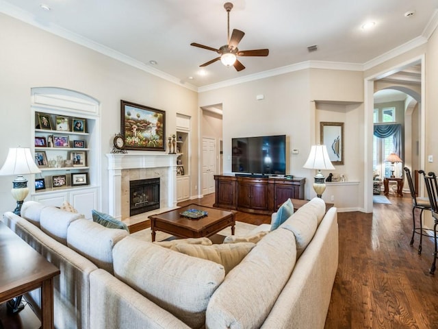 7805 Chapel View Dr, Mckinney, TX 75072 - living room featuring a ceiling fan, arched walkways, dark wood-style floors, crown molding, and baseboards
