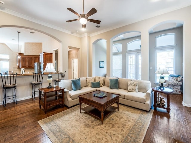 7805 Chapel View Dr, Mckinney, TX 75072 - living room with ceiling fan, dark wood-style floors, ornamental molding, arched walkways, and baseboards