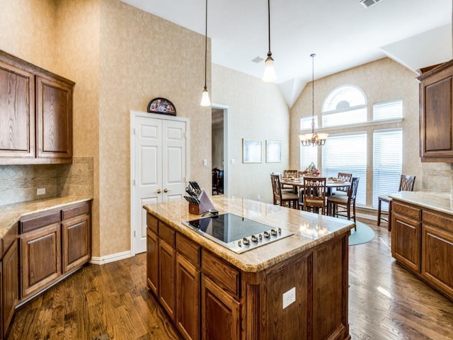 7805 Chapel View Dr, Mckinney, TX 75072 - kitchen featuring high vaulted ceiling, black electric cooktop, a chandelier, dark wood-style floors, and decorative backsplash