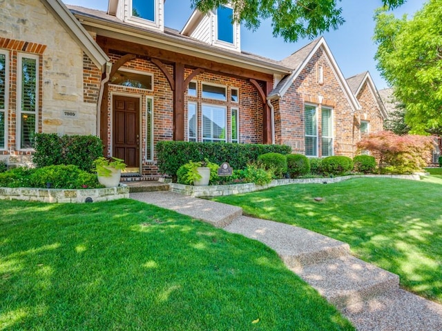 7805 Chapel View Dr, Mckinney, TX 75072 - view of front of house with brick siding, a front yard, and stone siding