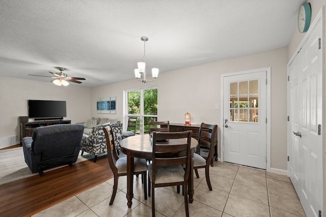 7201 Winchester Rd, North Richland Hills, TX 76182 - dining space with light tile patterned floors, a chandelier, ceiling fan, and baseboards