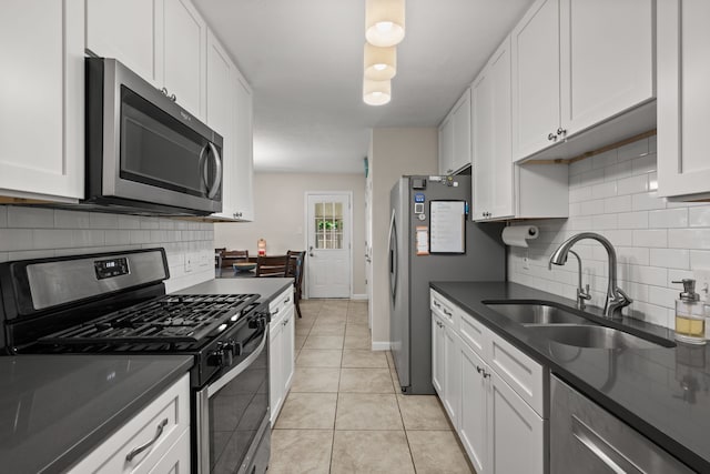 7201 Winchester Rd, North Richland Hills, TX 76182 - kitchen featuring appliances with stainless steel finishes, a sink, dark countertops, and tasteful backsplash