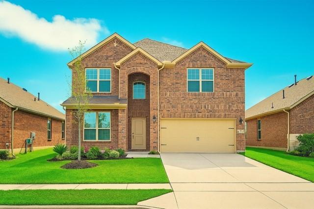 11216 Ponderosa Trl, Aubrey, TX 76227 - traditional-style house featuring brick siding, a garage, driveway, and a front lawn