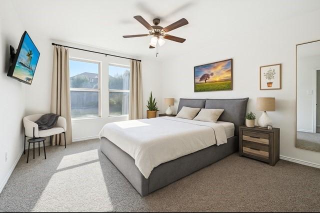 11216 Ponderosa Trl, Aubrey, TX 76227 - bedroom with carpet flooring, baseboards, and a ceiling fan