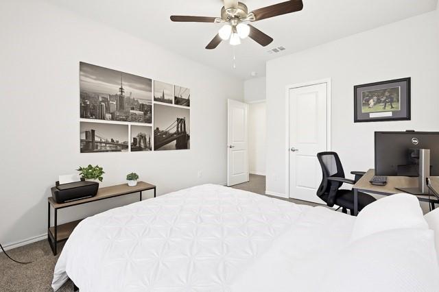 11216 Ponderosa Trl, Aubrey, TX 76227 - carpeted bedroom with baseboards, ceiling fan, and a desk