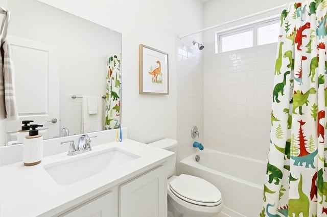 11216 Ponderosa Trl, Aubrey, TX 76227 - bathroom featuring vanity, toilet, and shower / bath combo with shower curtain