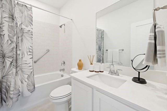 11216 Ponderosa Trl, Aubrey, TX 76227 - bathroom with vanity, toilet, and shower / bath combo with shower curtain