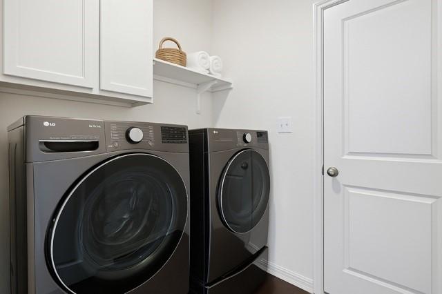 11216 Ponderosa Trl, Aubrey, TX 76227 - washroom featuring independent washer and dryer, cabinet space, and baseboards