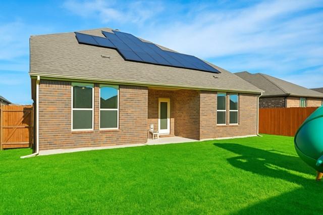 11216 Ponderosa Trl, Aubrey, TX 76227 - rear view of house featuring solar panels and brick siding