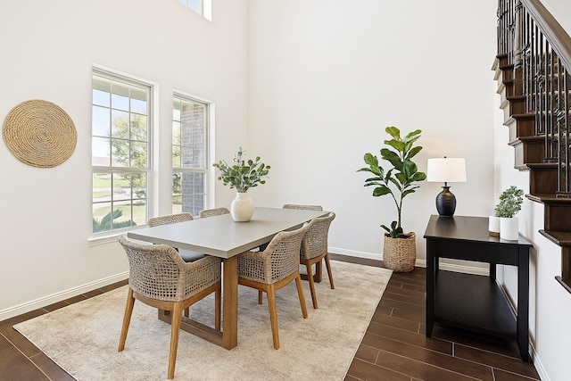 11216 Ponderosa Trl, Aubrey, TX 76227 - dining space with plenty of natural light, dark wood-style floors, baseboards, stairway, and a towering ceiling