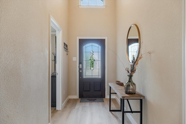 4708 River Edge Pl, Frisco, TX 75036 - foyer with light wood finished floors, baseboards, a textured wall, and a high ceiling