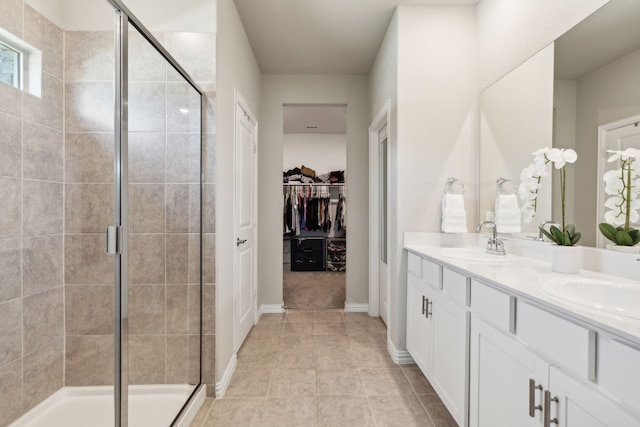 452 Ella Ln, Fate, TX 75087 - full bath featuring a stall shower, double vanity, a spacious closet, and tile patterned floors