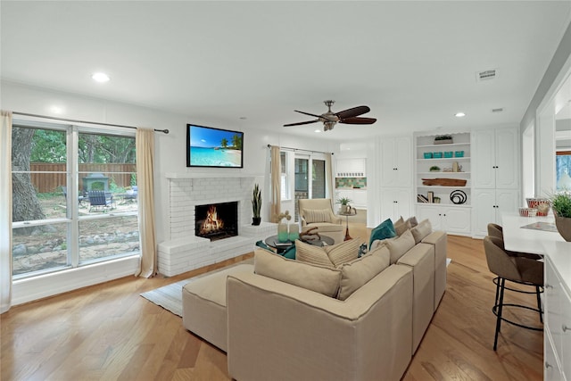 205 N College St, Mckinney, TX 75069 - living area with light wood-type flooring, a fireplace, a ceiling fan, and recessed lighting