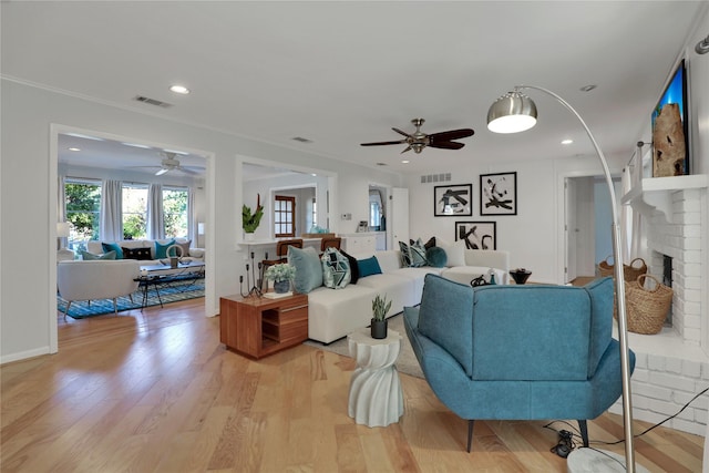 205 N College St, Mckinney, TX 75069 - living area with ceiling fan, light wood finished floors, a brick fireplace, and recessed lighting