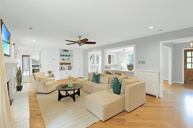 205 N College St, Mckinney, TX 75069 - living area with ceiling fan, light wood-type flooring, a brick fireplace, recessed lighting, and built in shelves
