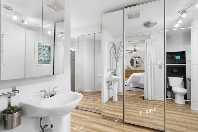 205 N College St, Mckinney, TX 75069 - ensuite bathroom featuring toilet, wood finished floors, a shower stall, a ceiling fan, and ornamental molding