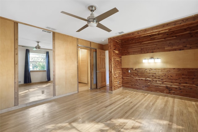 205 N College St, Mckinney, TX 75069 - unfurnished bedroom featuring wood walls, wood finished floors, a ceiling fan, and baseboards