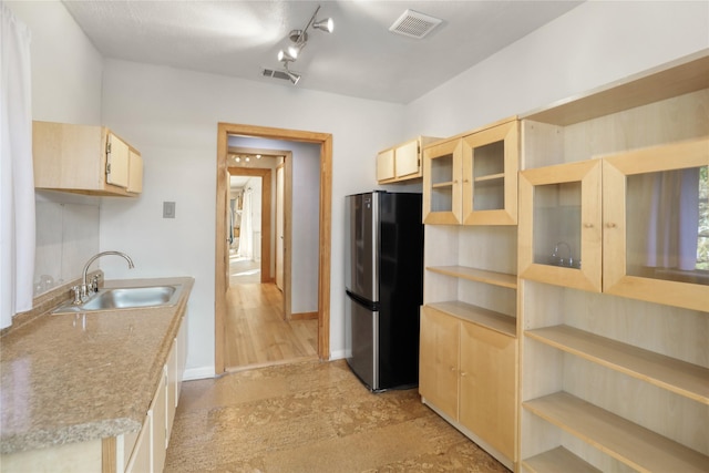 205 N College St, Mckinney, TX 75069 - kitchen with freestanding refrigerator, a sink, light brown cabinets, and open shelves