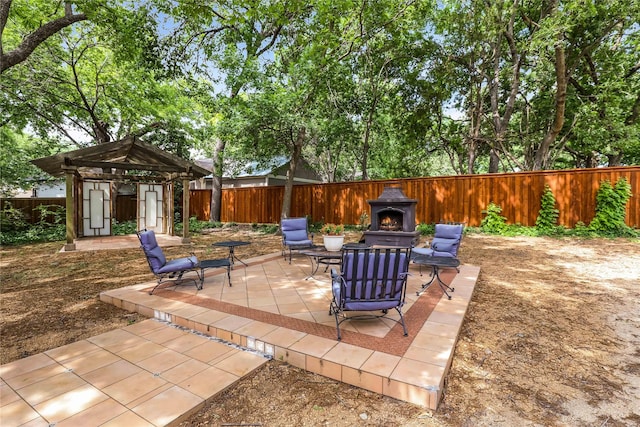 205 N College St, Mckinney, TX 75069 - fenced backyard featuring a patio area, a lit fireplace, and a gazebo