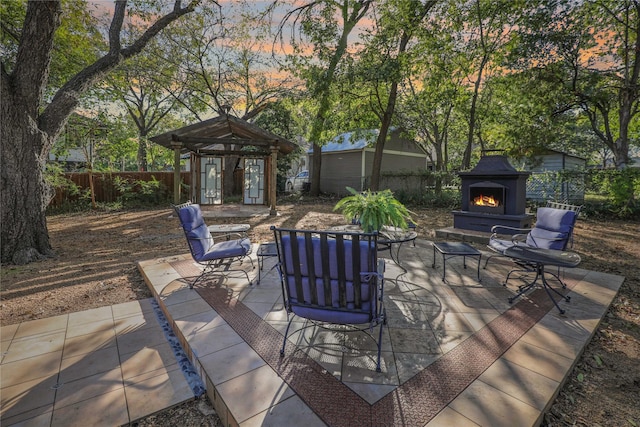 205 N College St, Mckinney, TX 75069 - view of patio / terrace featuring a warm lit fireplace
