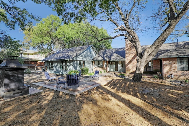 205 N College St, Mckinney, TX 75069 - rear view of property with a chimney and a patio area