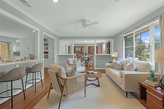 205 N College St, Mckinney, TX 75069 - living room featuring a ceiling fan, light wood-style floors, recessed lighting, and crown molding