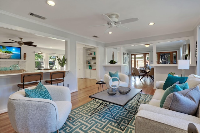205 N College St, Mckinney, TX 75069 - living room featuring ceiling fan, light wood-style flooring, ornamental molding, recessed lighting, and baseboards