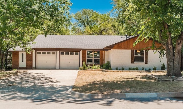 2908 Longfellow Ln, Denton, TX 76209 - view of front of home featuring an attached garage, driveway, brick siding, and roof with shingles