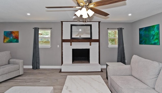 2908 Longfellow Ln, Denton, TX 76209 - living room featuring baseboards, wood finished floors, recessed lighting, ceiling fan, and a brick fireplace