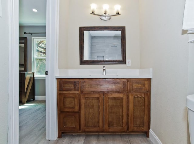 2908 Longfellow Ln, Denton, TX 76209 - bathroom featuring vanity, wood finished floors, and baseboards