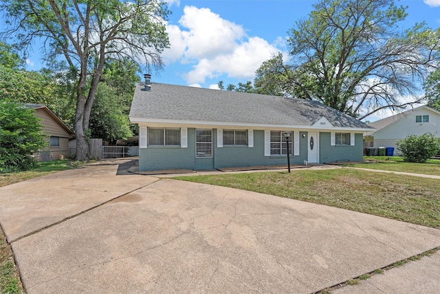 3412 Lisbon Dr, Waco, TX 76706 - view of front of property with brick siding, driveway, and a shingled roof
